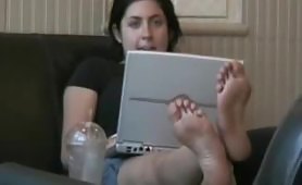 Hard working girl soles while busy on PC