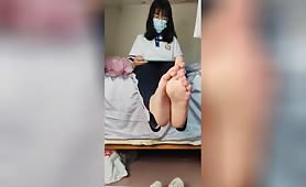 A chinese schoolgirl shows her feet