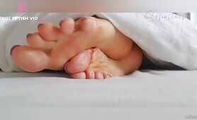 Ignoring sleepy big soles of sofiastoes in her bed sheets